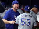 Adolis Garcia celebrates with Max Scherzer of the Texas Rangers after defeating the Tampa Bay Rays in 2023.