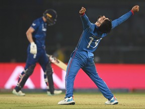Rashid Khan of Afghanistan celebrates the wicket of Mark Wood of England to win by 69 runs during the ICC Men's Cricket World Cup.