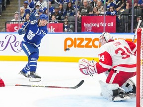 Matthew Knies of the Toronto Maple Leafs shoots at Detroit Red Wings goalie Alex Lyon.