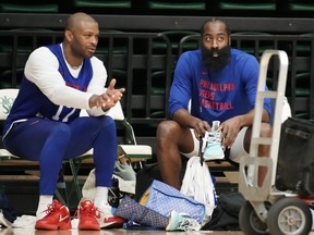 Philadelphia 76ers guard James Harden chats with forward P.J. Tucker during practice.