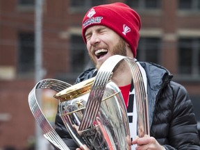 Toronto FC midfielder Michael Bradley celebrates with the MLS Cup during Toronto FC's parade in 2017.