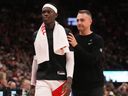 Toronto Raptors' Dennis Schroder and head coach Darko Rajakovic make their way to the bench during pre-season action.