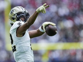 New Orleans Saints wide receiver Chris Olave (12) reacts after a long first down reception against the Houston Texans.