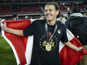 Christine Sinclair of Portland Thorns FC drapes the Canadian flag around herself.