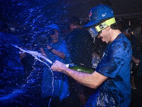 Jordan Romano of the Toronto Blue Jays sprays champagne.