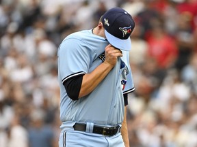 Erik Swanson of the Toronto Blue Jays walks back to the dugout.