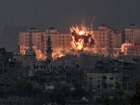 A fireball erupts during Israeli bombardment in the northern Gaza Strip on Saturday, Oct. 14, 2023.