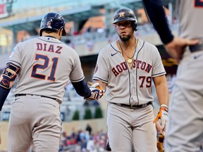 Yainer Diaz #21 and José Abreu #79 of the Houston Astros celebrate after Abreu hit a home run in the ninth inning against the Minnesota Twins during Game Three of the Division Series at Target Field on October 10, 2023 in Minneapolis, Minnesota.