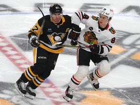 Connor Bedard #98 of the Chicago Blackhawks skates against Sidney Crosby #87 of the Pittsburgh Penguins during the first period at PPG PAINTS Arena on October 10, 2023 in Pittsburgh.
