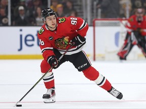 Connor Bedard of the Chicago Blackhawks skates with the puck.