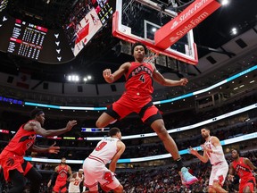 Scottie Barnes #4 of the Toronto Raptors leaps over Zach LaVine #8 of the Chicago Bulls during the first half at the United Center on October 17, 2023 in Chicago, Illinois. (Photo by Michael Reaves/Getty Images)