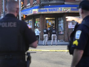 Law enforcement officials investigate the scene where multiple were shot, Wednesday, Oct. 4, 2023, in Holyoke, Mass.