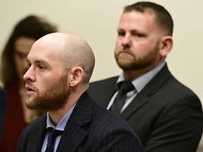 Former Aurora, Colo., police officer Jason Rosenblatt, left, and Aurora police officer Randy Roedema, right, attend an arraignment at the Adams County Justice Center, Jan. 20, 2023, in Brighton, Colo.