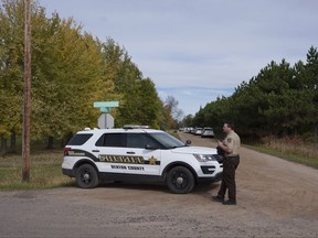 A Benton County sheriff establishes a security perimeter at the intersection of 186th Avenue NE and Glendorado Road NE near Princeton, Minn, following a "critical incident" that resulted in the shooting of law enforcement officers, Thursday, Oct. 12, 2023.