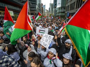 A pro-Palestine march makes its way north along Bay St.