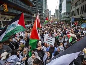 Pro-Palestinian march makes its way north along Bay St. in downtown Toronto on Monday, October 9, 2023.