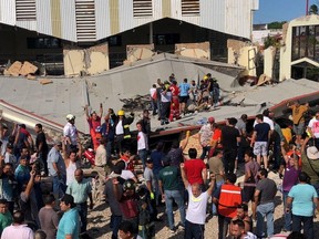This handout picture released by the Tamaulipas Civil Protection shows rescuers and members of Civil Protection working to rescue people who were trapped after a church roof collapsed in Ciudad Madero, Tamaulipas State, Mexico, on October 1, 2023.