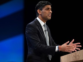 Britain's Prime Minister Rishi Sunak addresses delegates at the annual Conservative Party Conference in Manchester, northern England, on October 4, 2023. (Photo by OLI SCARFF/AFP via Getty Images)