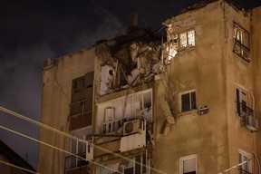 A building in Tel Aviv is damaged by a rocket fired by Palestinian militants from the Gaza Strip on Oct. 7, 2023.