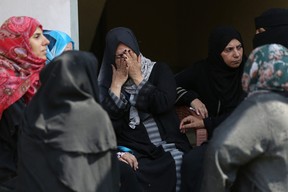 Relatives mourn members of the Abu Daka family who were killed in Israeli strikes on the southern Gaza Strip during their funeral on Oct. 8, 2023 in Khan Yunis.