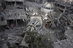 Palestinians inspect the destruction around Ahmed Yassin mosque, which was levelled by Israeli airstrikes, in Gaza City early on October 9, 2023. (Photo by MOHAMMED ABED/AFP via Getty Images)
