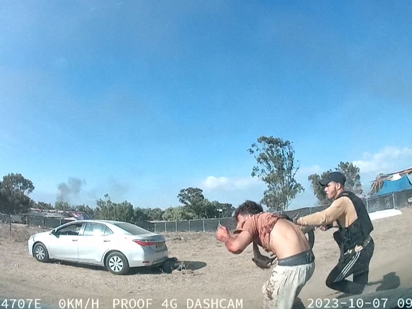 A grab from a UGC video posted on Telegram on October 9, 2023, shows an armed Palestinian militant leading a man during the Supernova music festival, near Kibbutz Reim in the Negev desert in southern Israel. Hamas gunmen killed around 250 people who attended an outdoor music festival in an Israeli community near Gaza at the weekend, a volunteer who helped collect the bodies said on Monday. (Photo by ANONYMOUS/AFP via Getty Images)