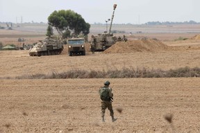 Israeli army artillery are positioned towards Gaza near the border with the Palestinian territory in southern Israel on October 9, 2023. Israel continued to battle Hamas fighters on October 9 and massed tens of thousands of troops and heavy armour around the Gaza Strip after vowing a massive blow over the Palestinian militants' surprise attack. (Photo by JACK GUEZ/AFP via Getty Images)