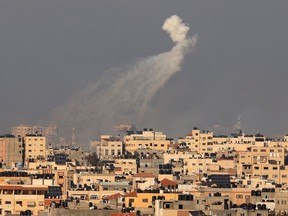 A rocket fired by Israel explodes over Gaza City on October 10, 2023. I
