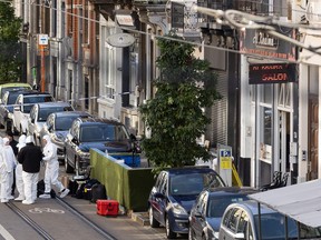 Belgian police officers from the forensic service gather in the street in the Schaerbeek area of Brussels on October 17, 2023, where the suspected perpetrator of the attack in Brussels was shot dead during a police intervention. Brussels police on October 17, 2023 shot and fatally wounded an attacker accused of gunning down two Swedish football fans in what Belgium's prime minister condemned as an act of "terrorist madness". (Photo by JAMES ARTHUR GEKIERE / BELGA / AFP) / Belgium OUT (Photo by JAMES ARTHUR GEKIERE/BELGA/AFP via Getty Images)