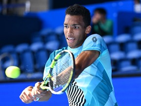 Canada's Felix Auger-Aliassime hits a return against Austria's Sebastian Ofner during their men's singles match on day three of the ATP Japan Open tennis tournament in Tokyo on October 18, 2023. (Photo by KAZUHIRO NOGI/AFP via Getty Images)
