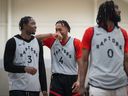 The Toronto Raptors' OG Anunoby (3) jokes with Scottie Barnes (4) as they stand behind Javon Freeman-Liberty (0) during the opening day of the NBA team's training camp, in Burnaby, B.C., on Oct. 3, 2023.