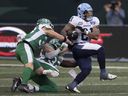 Argonauts running back Daniel Adeboboye (right) runs the ball during second half CFL action at Mosaic Stadium in Regina, Saturday, Oct. 21, 2023.