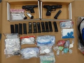 Police in Durham charged two people from Bowmanville after guns and drugs were seized Friday.