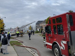 Brampton firefighters battle a house fire on Hollybush St. that killed on adult and sent three people, a woman and two kids, to hospital on Saturday, Oct. 21, 2023.