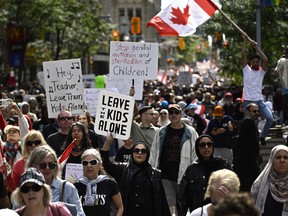 Protesters march on Bank Street in Ottawa during a demonstration against sexual orientation and gender identity programs in schools on Sept. 20, 2023. The protest was one of many across Canada, organized by "1MillionMarch4Children," as they protest against so-called "gender ideology" being taught in schools.