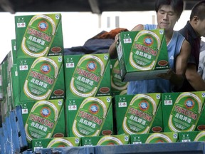 Workers load boxes of Tsingtao beer on to a truck at one of the four breweries in the eastern Chinese port city of Qingdao.