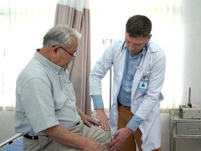 Elderly man talking and consulting with doctor