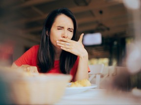 Woman Feeling Sick and Disgusted by Food Course in a Restaurant
