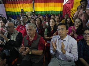 LGBTQ community supporters and members wait for the Supreme Court verdict on petitions that seek the legalization of same-sex marriage, in Mumbai, India, Tuesday, Oct. 17, 2023.