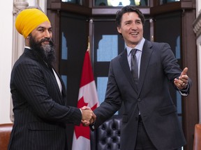 Jagmeet Singh and Justin Trudeau smiling and shaking hands