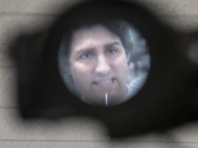 Prime Minister Justin Trudeau is seen through the eye piece of a video camera