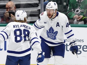 Maple Leafs' Morgan Rielly (right) is congratulated by forward William Nylander after scoring a goal against the Dallas Stars on Thursday, Oct. 26, 2023, in Dallas.