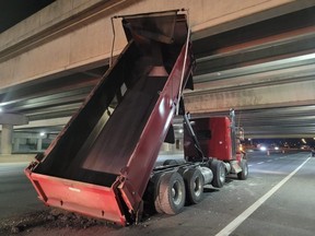 The OPP are investigating after a dump truck with its bucket raised struck a highway overpass north of Toronto.