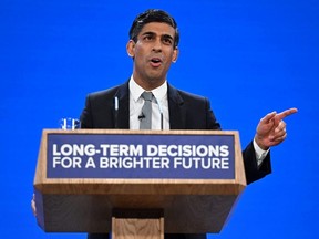 Britain's Prime Minister Rishi Sunak addresses delegates at the annual Conservative Party Conference in Manchester, Wednesday, Oct. 4, 2023.