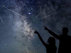 A family watches a meteor shower.