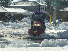A sidewalk snowplow does its thing a few days after a heavy snowfall on Ferris Rd. in East York on Monday, March 27, 2023.