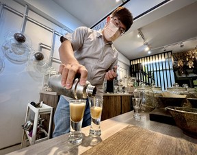 Bryan Wang, 34, owner of the Healing Herbar makes a drink out of whiskey, herbal tea and honey in Taipei City, Taiwan on Tuesday, May 30, 2023.