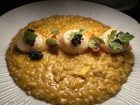 Cream risotto, made with sea urchin is a bold orange, topped with scallops and mullet roe at Fleisch Café, along Dihua St. in Dadaocheng area Taipei City, Taiwan on Tuesday, May 30, 2023.