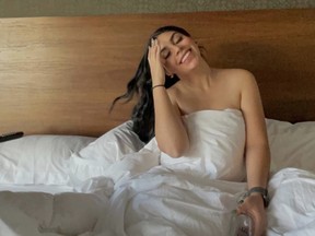 Smiling woman sitting up in bed
