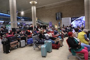 Passengers wait at Ben Gurion Airport near Tel Aviv, Israel, on Oct. 7, 2023, as flights are cancelled because of the Hamas surprise attack.